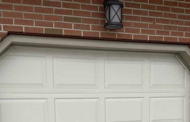 A service van parked in front of an open garage