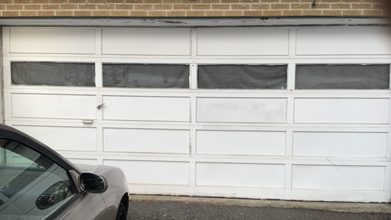 A dented lower section of a garage door