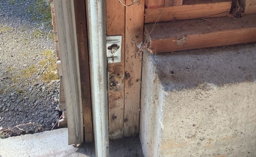 A technician working on an open garage door